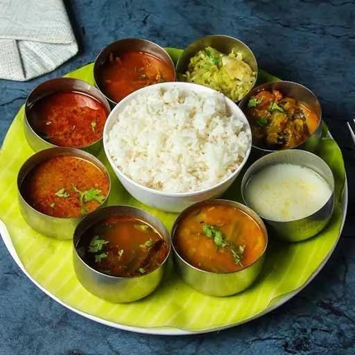 Traditional banana leaf virundhu meal with sambar, rasam, and sides from Sathya Catering Services